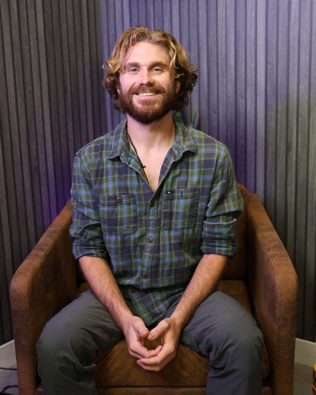 Xander Ward seated, smiling